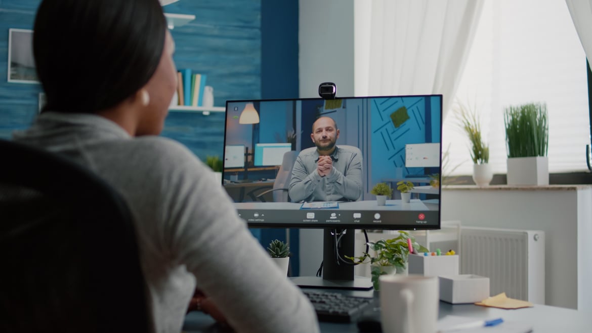 Employee participating in a virtual coaching session, showcasing tools that support connected learning, coaching, and employee development in a flexible work environment.